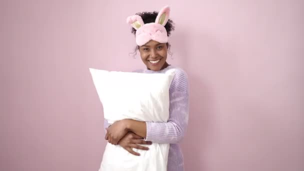 Afrikansk Amerikansk Kvinna Bär Sömnmask Krama Kudde Över Isolerade Rosa — Stockvideo