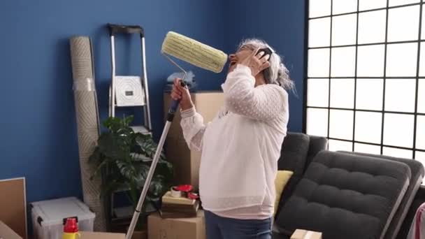 Middle Age Grey Haired Woman Singing Song Using Paint Roller — Stock Video