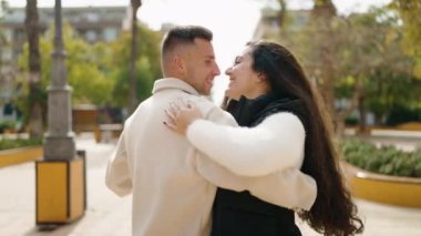 Young couple smiling confident dancing at park