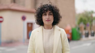 Sokakta kendinden emin gülümseyen genç bir kadın