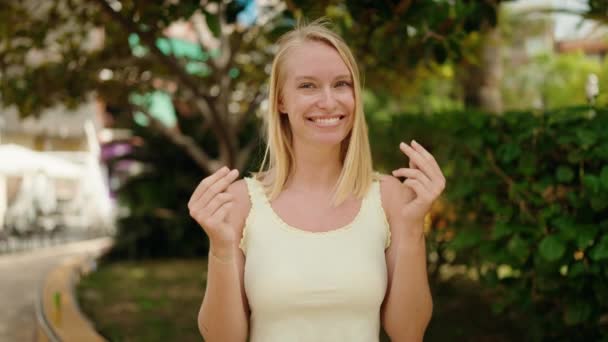 Young Blonde Woman Smiling Confident Doing Spend Money Gesture Park — Stock videók