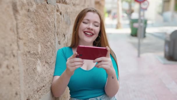 Νεαρή Κοκκινομάλλα Γυναίκα Χαμογελά Αυτοπεποίθηση Βλέποντας Βίντεο Στο Smartphone Στο — Αρχείο Βίντεο