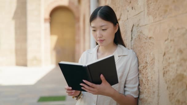 Chinese Woman Smiling Confident Reading Book Street — kuvapankkivideo