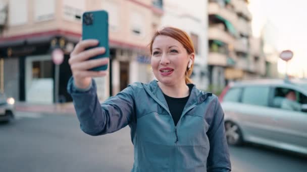 Young Redhead Woman Wearing Sportswear Having Video Call Street — Vídeos de Stock