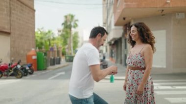 Man and woman couple surprise with engagement ring at street