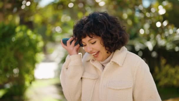 Молода Іспаномовна Жінка Посміхається Впевнено Слухаючи Аудіоповідомлення Смартфона Парку — стокове відео