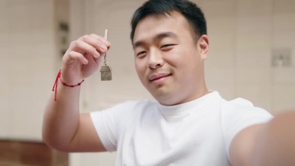 Young Chinese Man Holding Key New Home Having Video Call — 图库视频影像