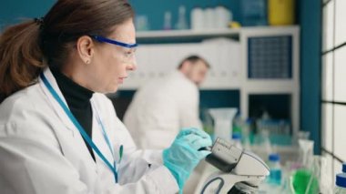 Man and woman scientists working at laboratory