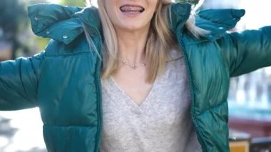 Young blonde woman smiling happy with open arms at park