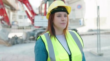 Young beautiful plus size woman architect smiling confident doing ok gesture with thumb up at street