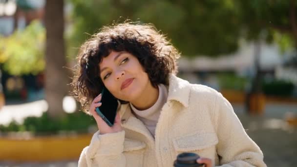 Young Hispanic Woman Talking Smartphone Drinking Coffee Park — Stok video