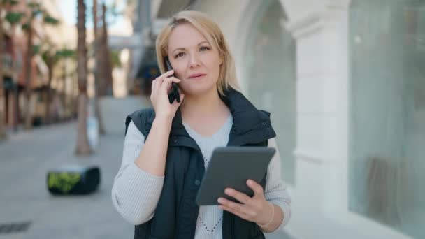 Young Blonde Woman Talking Smartphone Using Laptop Street — Stockvideo