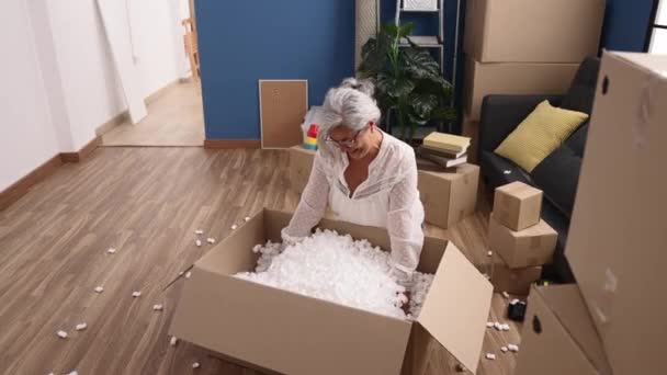 Middle Age Grey Haired Woman Smiling Confident Unboxing Package Playing — Vídeos de Stock