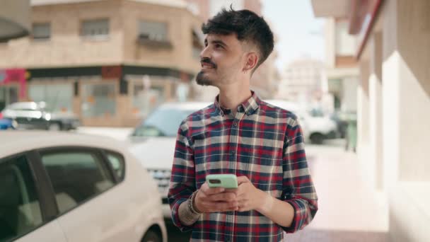 Młody Hiszpan Uśmiecha Się Pewnie Używając Smartfona Ulicy — Wideo stockowe