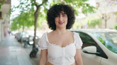 Young middle east woman smiling confident doing photo gesture with hands at street