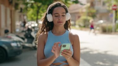 Sokak ortasında müzik dinleyen ve dans eden genç, güzel İspanyol kadın.