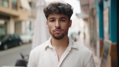 Young arab man smiling confident standing at street