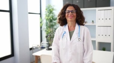 Middle age hispanic doctor woman with crossed arms