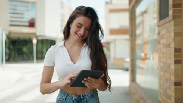 Young Hispanic Woman Smiling Confident Using Touchpad Walking Street — 图库视频影像