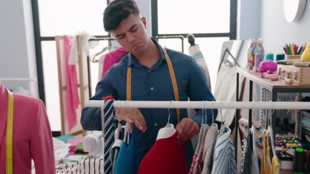 Young Hispanic Man Tailor Smiling Confident Holding Clothes Rack Clothing — Video Stock