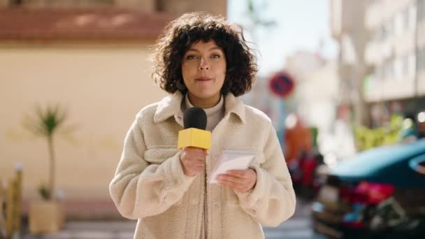 Young Hispanic Woman News Reporter Speaking Using Microphone Street — Vídeos de Stock