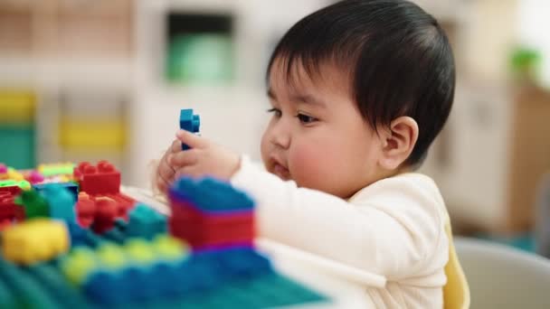 Adorable Hispanic Baby Playing Construction Blocks Sitting Table Kindergarten — Stockvideo