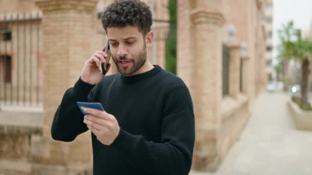 Young Arab Man Talking Smartphone Using Credit Card Street — Stockvideo