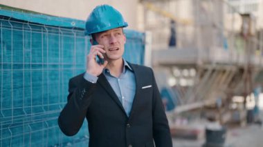 Young caucasian man architect smiling confident talking on the smartphone at street