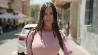 Genç, güzel, İspanyol bir kadın sokağın aşağısında 