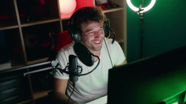 Young hispanic man streamer having video call at music studio