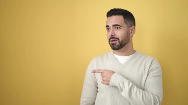 Young Hispanic Man Smiling Confident Pointing Fingers Side Isolated Yellow — Stok video