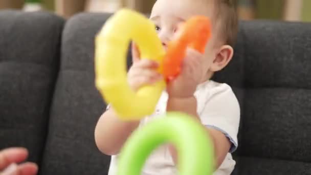 Adorable Toddler Playing Hoops Sitting Sofa Bitting Hoop Home — Stockvideo