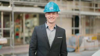 Young caucasian man architect standing with arms crossed gesture at street