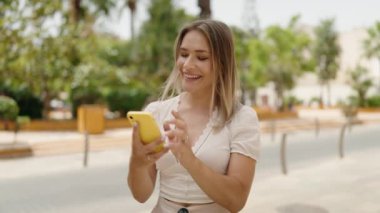 Young caucasian woman smiling confident having video call at street