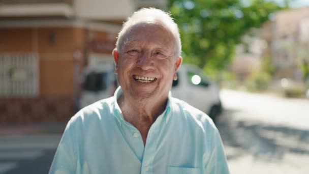 Senior Grey Haired Man Smiling Confident Doing Sign Thumb Street — стоковое видео