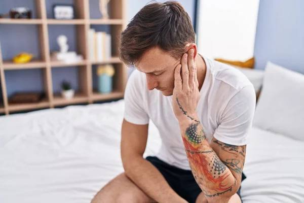 Young Man Suffering Ear Pain Sitting Bed Bedroom — Stock Photo, Image