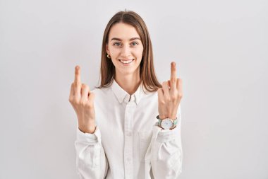 Young caucasian woman standing over isolated background showing middle finger doing fuck you bad expression, provocation and rude attitude. screaming excited 