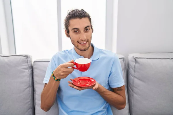 Young Hispanic Man Drinking Coffee Sitting Sofa Home — Stock Photo, Image