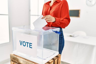 Young woman voting at electoral college