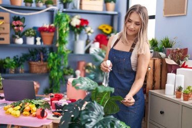Young caucasian woman florist smiling confident working at florist