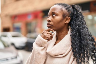 African american woman standing with doubt expression at street