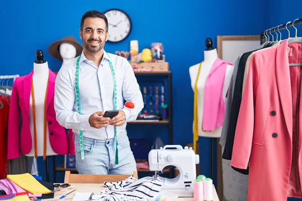 Young Hispanic Man Tailor Smiling Confident Using Smartphone Sewing Studio — Stock Photo, Image