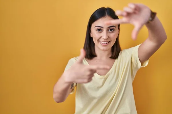 Hispanic Girl Wearing Casual Shirt Yellow Background Smiling Making Frame — Stock Photo, Image