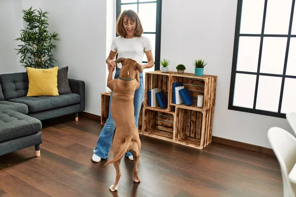 stock image Young caucasian woman smiling confident dancing with dog at home