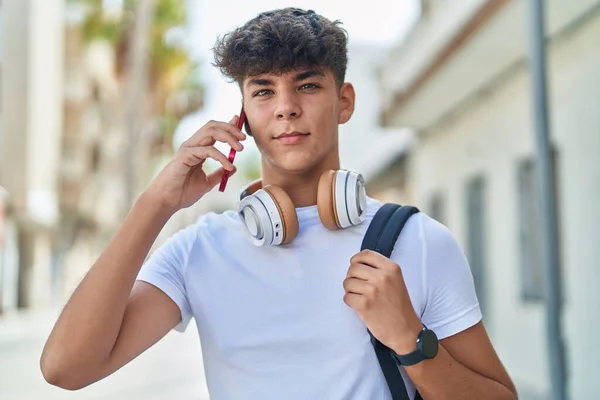 Young Hispanic Teenager Student Talking Smartphone Relaxed Expression Street —  Fotos de Stock