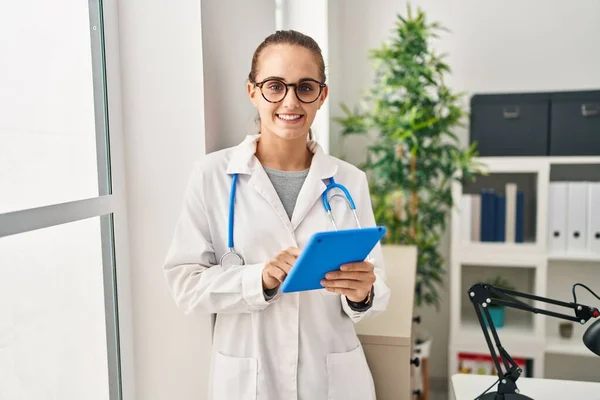 Young Blonde Woman Wearing Doctor Uniform Using Touchpad Working Clinic — Fotografia de Stock