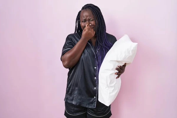 Young African Woman Wearing Pijama Hugging Pillow Smelling Something Stinky — Stock Photo, Image