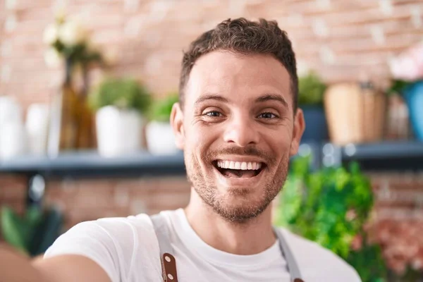 stock image Young hispanic man florist smiling confident make selfie by camera at florist