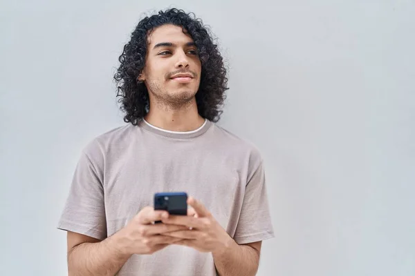 Giovane Uomo Latino Sorridente Fiducioso Utilizzando Smartphone Sfondo Bianco Isolato — Foto Stock