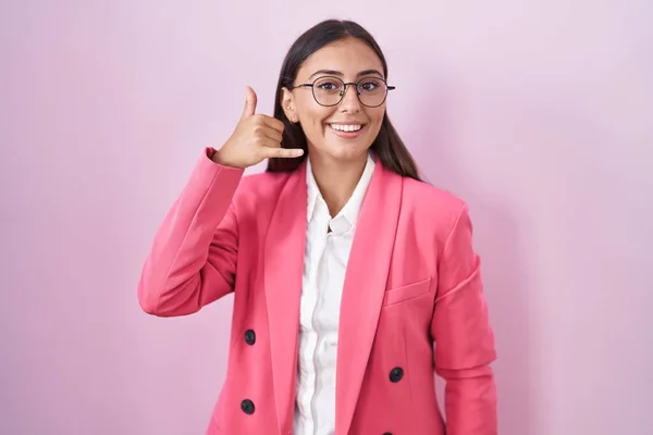 若いヒスパニック系の女性がビジネス服を着て 眼鏡を手や指で電話で話をするような携帯電話のジェスチャーを行う笑顔 コミュニケーションの概念 — ストック写真